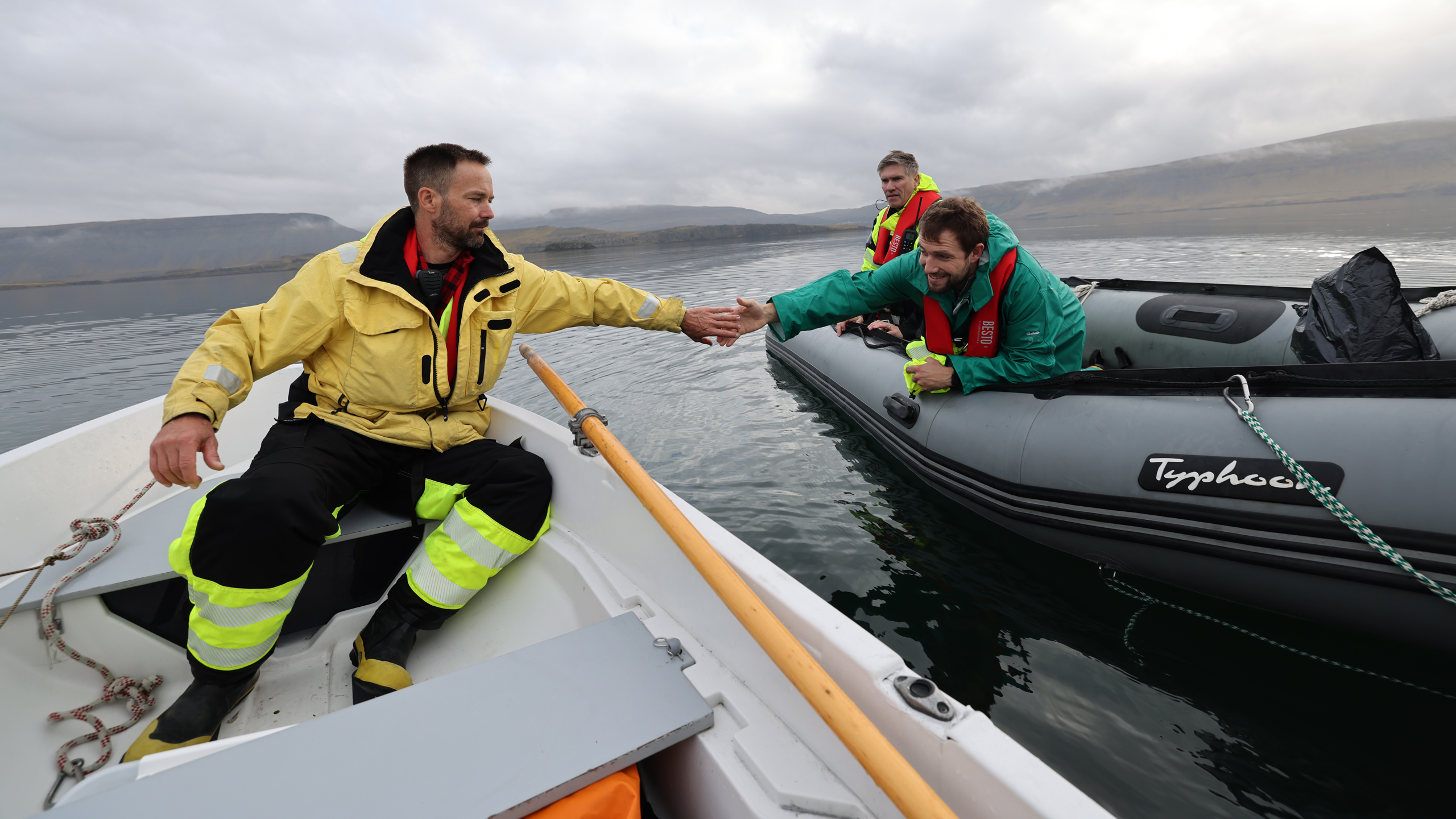Researchers from the University of Hawaii and Röst Marine Research Center meet in the waters of a fjord during a dye study of ocean currents in Iceland. (Danny Gawlowski / Carbon to Sea)