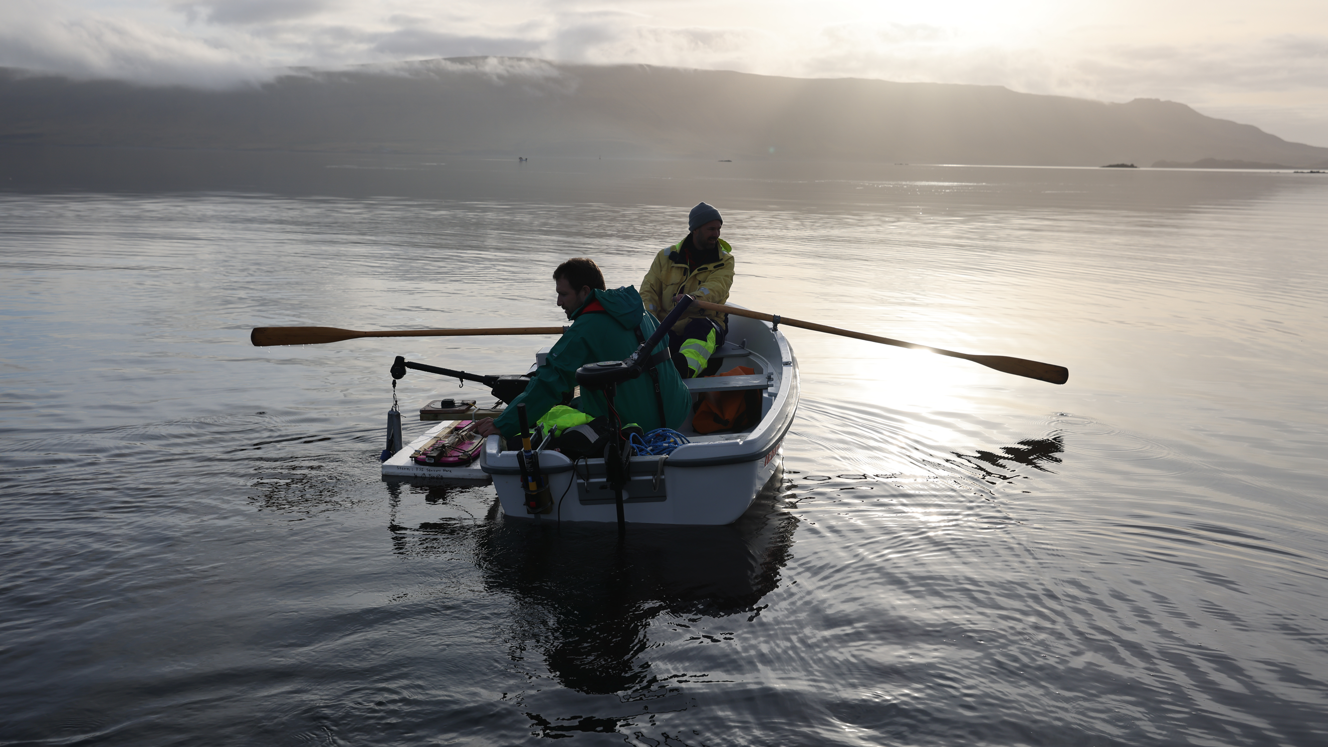 Measurements are taken from a rowboat during a dye study of ocean currents in Iceland. (Danny Gawlowski / Carbon to Sea)